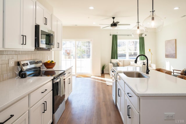 128 Brenleigh Ct Unit 208, Lynchburg, VA 24501 - kitchen featuring appliances with stainless steel finishes, a sink, open floor plan, backsplash, and dark wood-style flooring