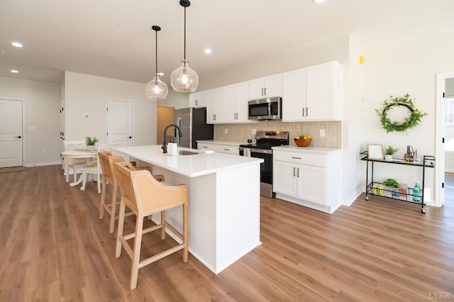 128 Brenleigh Ct Unit 208, Lynchburg, VA 24501 - kitchen with stainless steel appliances, a sink, light wood-type flooring, tasteful backsplash, and recessed lighting