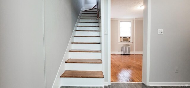 4065 Fort Ave, Lynchburg, VA 24502 - stairs featuring wood finished floors, radiator heating unit, and baseboards
