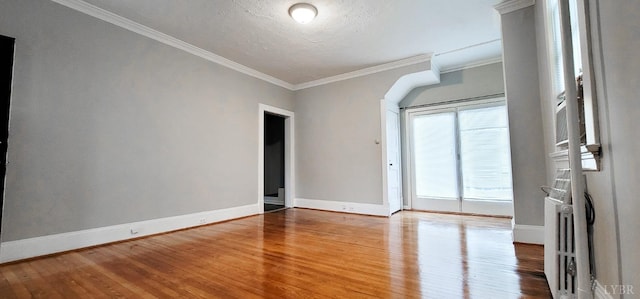 4065 Fort Ave, Lynchburg, VA 24502 - spare room with wood finished floors, baseboards, crown molding, arched walkways, and a textured ceiling