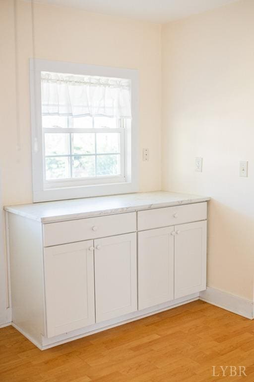 67 Lentz Ln, Shipman, VA 22971 - kitchen featuring light wood-type flooring, white cabinetry, light countertops, and baseboards