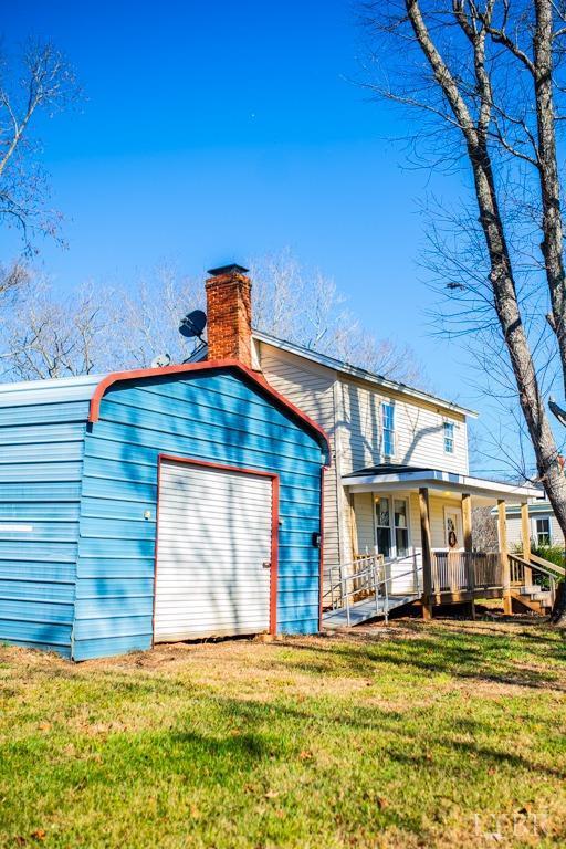 67 Lentz Ln, Shipman, VA 22971 - view of front of home featuring a garage, a front lawn, a chimney, and a porch