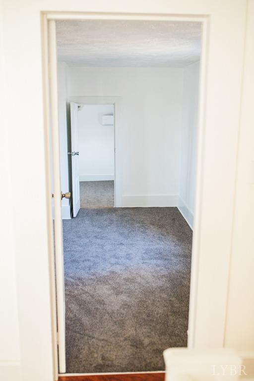 67 Lentz Ln, Shipman, VA 22971 - hallway with carpet floors, baseboards, and an AC wall unit