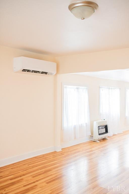 67 Lentz Ln, Shipman, VA 22971 - unfurnished living room featuring a wall mounted AC, heating unit, wood finished floors, and baseboards