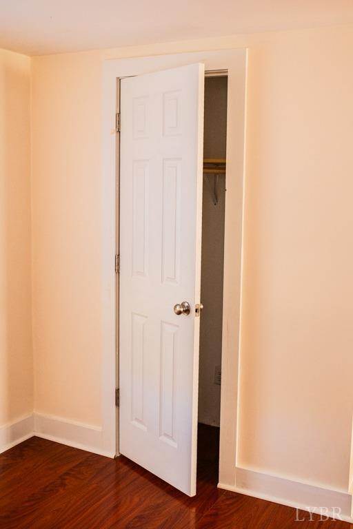 67 Lentz Ln, Shipman, VA 22971 - unfurnished bedroom featuring dark wood-type flooring, baseboards, and a closet