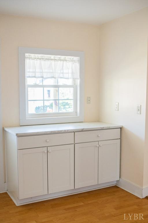 67 Lentz Ln, Shipman, VA 22971 - kitchen with baseboards, light wood finished floors, light countertops, and white cabinetry