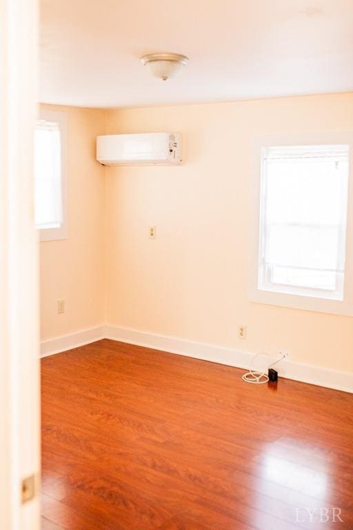 67 Lentz Ln, Shipman, VA 22971 - unfurnished room featuring a wall mounted air conditioner, wood finished floors, and baseboards