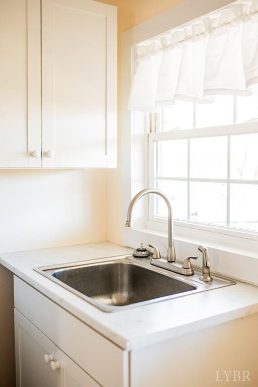 67 Lentz Ln, Shipman, VA 22971 - kitchen featuring a sink, light countertops, and white cabinetry
