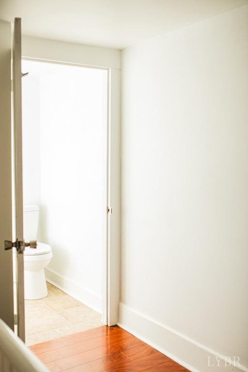 67 Lentz Ln, Shipman, VA 22971 - bathroom featuring toilet, baseboards, and wood finished floors