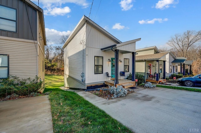 3047 Fulton St, Lynchburg, VA 24501 - view of front of property featuring board and batten siding, a front yard, and covered porch