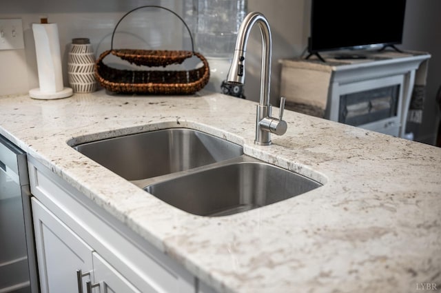 3047 Fulton St, Lynchburg, VA 24501 - detailed view of a sink, light stone counters, white cabinetry, and stainless steel dishwasher
