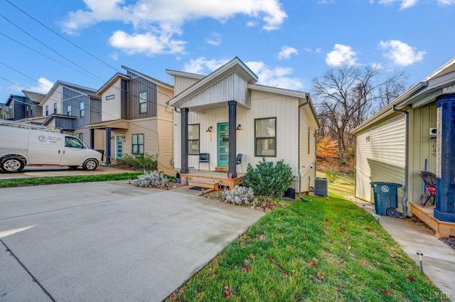 3047 Fulton St, Lynchburg, VA 24501 - view of property with central AC unit, a front lawn, board and batten siding, and a residential view