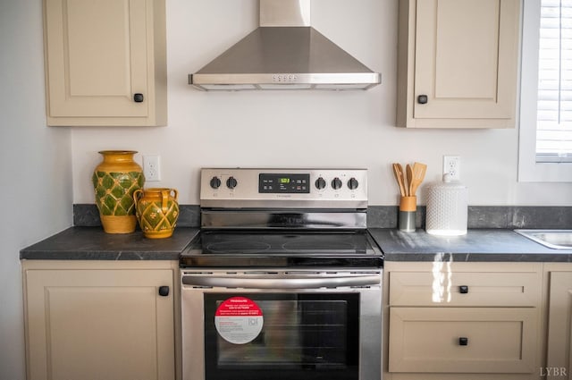 899 Union Hill Rd, Amherst, VA 24521 - kitchen featuring wall chimney range hood, stainless steel range with electric stovetop, dark countertops, and cream cabinetry