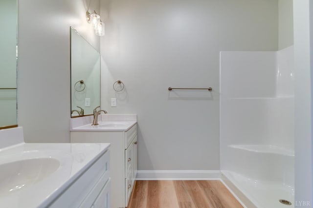 1327 Greenhouse Rd, Rustburg, VA 24588 - bathroom featuring a sink, two vanities, baseboards, and wood finished floors