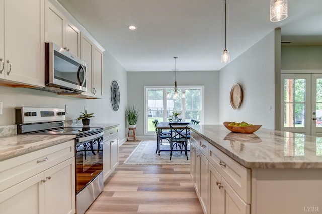 1327 Greenhouse Rd, Rustburg, VA 24588 - kitchen with plenty of natural light, stainless steel appliances, light stone countertops, and light wood-style floors