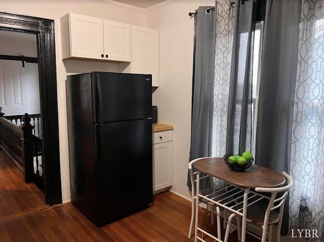 1014 Buchanan St, Lynchburg, VA 24501 - kitchen featuring freestanding refrigerator, crown molding, dark wood-type flooring, and white cabinetry