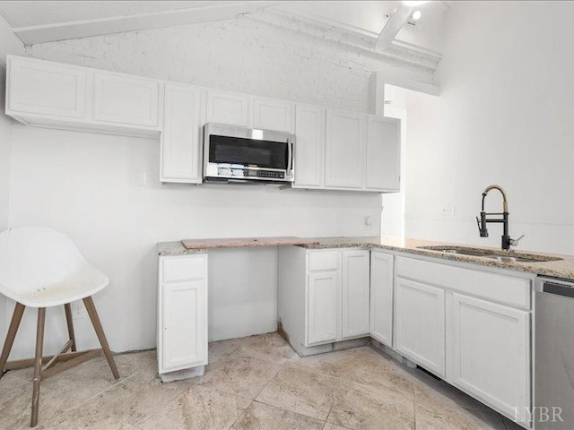 522 Jackson St, Lynchburg, VA 24504 - kitchen with lofted ceiling, light stone counters, stainless steel appliances, a sink, and white cabinetry