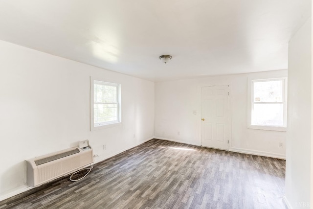 1930 Vine St, Lynchburg, VA 24501 - unfurnished room featuring baseboards, a wall mounted AC, and wood finished floors