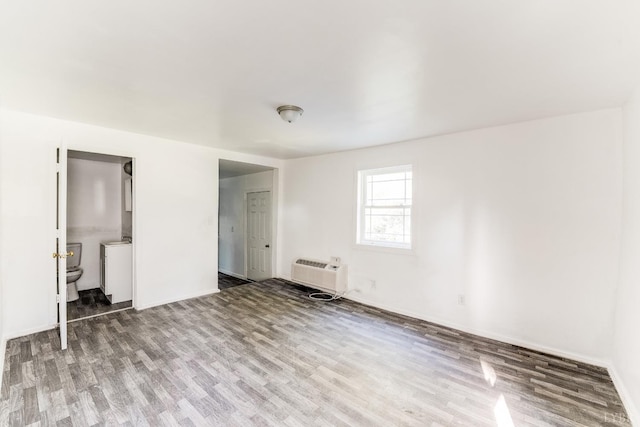 1930 Vine St, Lynchburg, VA 24501 - interior space with an AC wall unit, baseboards, and wood finished floors