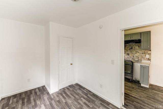 1930 Vine St, Lynchburg, VA 24501 - spare room featuring baseboards and dark wood-type flooring