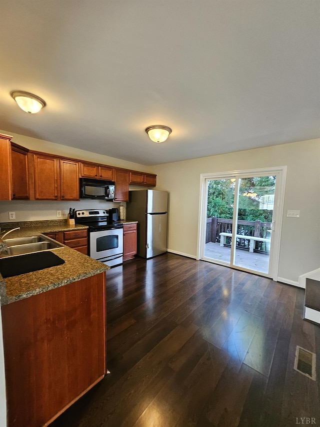 1810 Broadway St Unit 102, Lynchburg, VA 24501 - kitchen with brown cabinets, dark wood finished floors, stainless steel appliances, dark countertops, and a sink