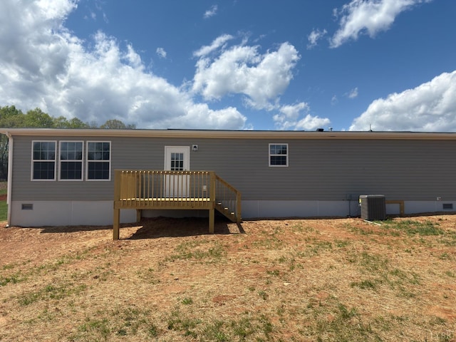 rear view of house with crawl space, a wooden deck, and central AC unit