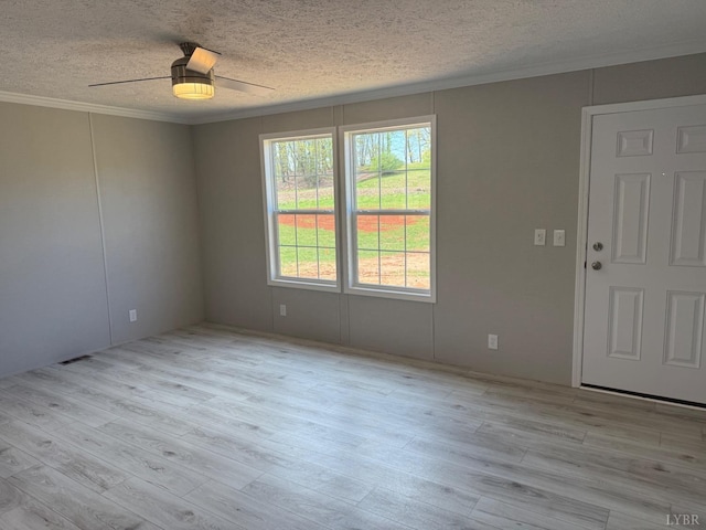 unfurnished room featuring ornamental molding, a textured ceiling, ceiling fan, and wood finished floors