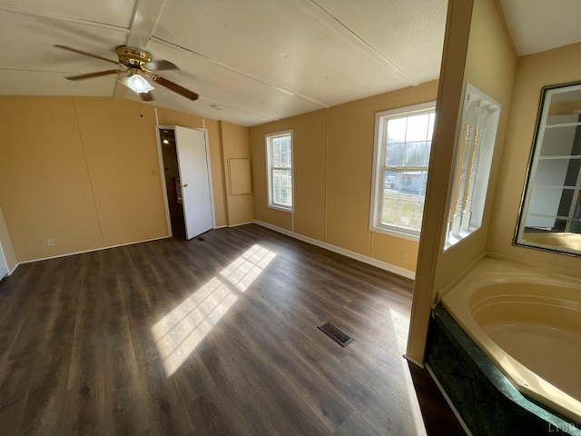 unfurnished room featuring vaulted ceiling, dark wood-style flooring, and ceiling fan