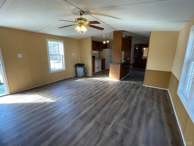 unfurnished living room with dark wood finished floors and ceiling fan