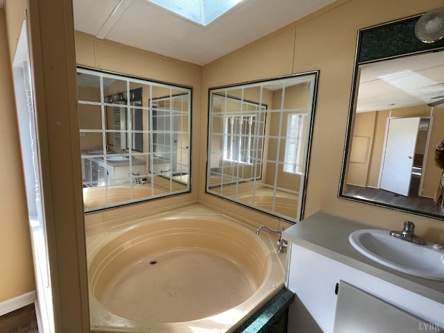 full bathroom with a garden tub and vanity