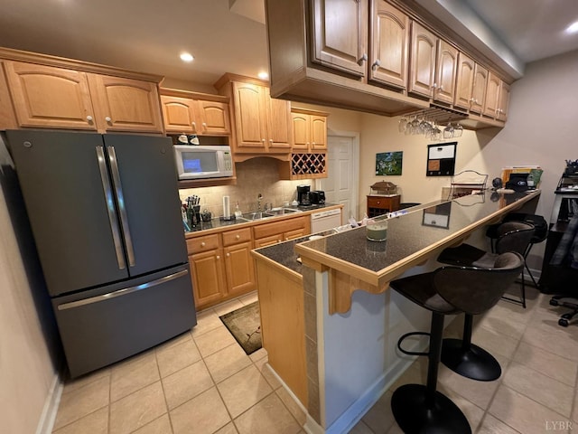 206 Blarney Stone Ct, Huddleston, VA 24104 - kitchen featuring white appliances, dark countertops, a peninsula, a kitchen bar, and a sink