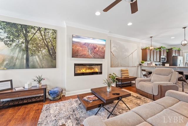 188 Mallard Ln, Lynchburg, VA 24502 - living room featuring ornamental molding, a glass covered fireplace, wood finished floors, ceiling fan, and recessed lighting