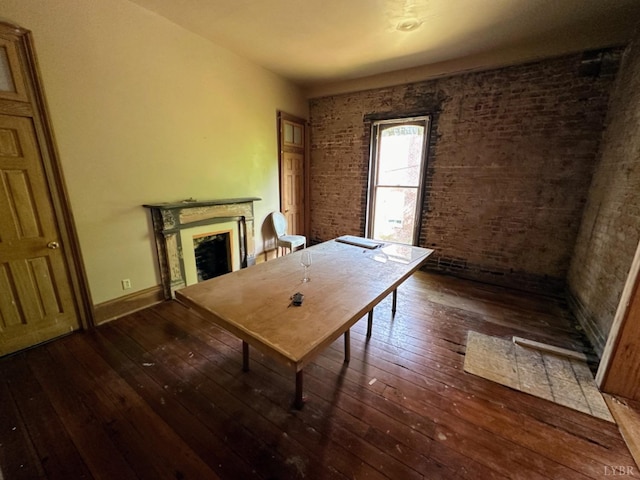 1020 Harrison St, Lynchburg, VA 24504 - office space with hardwood / wood-style floors, baseboards, brick wall, and a fireplace
