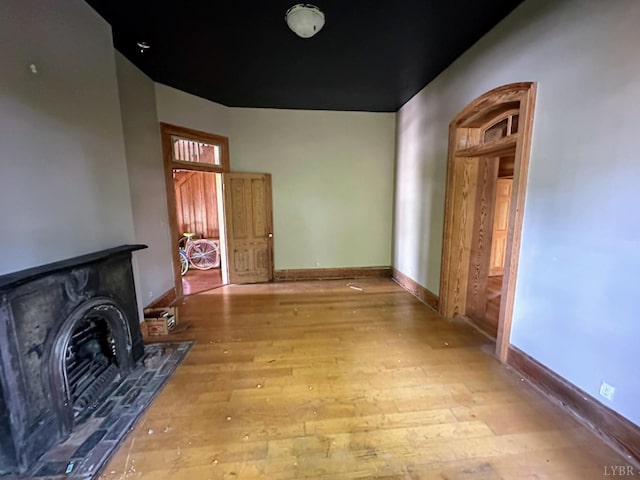 1020 Harrison St, Lynchburg, VA 24504 - living room featuring baseboards, wood finished floors, and a wood stove