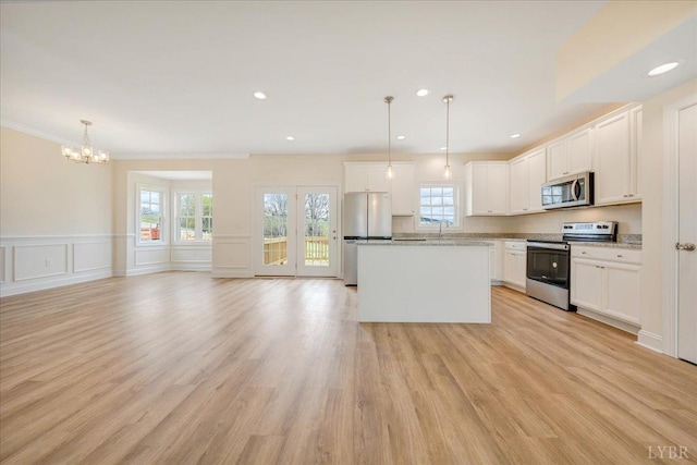 9 Lochwood Hill Dr, Goode, VA 24556 - kitchen with appliances with stainless steel finishes, a chandelier, a center island, a sink, and white cabinetry
