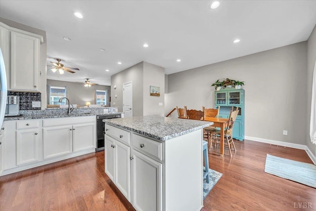59 Broad St, Daleville, VA 24083 - kitchen featuring ceiling fan, white cabinets, a sink, light wood-style flooring, and dishwasher