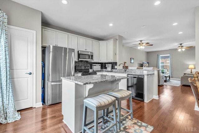 59 Broad St, Daleville, VA 24083 - kitchen with a peninsula, open floor plan, appliances with stainless steel finishes, and dark wood finished floors