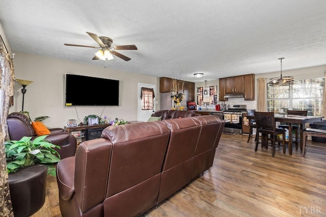 1117 Long Meadows Dr, Lynchburg, VA 24502 - living room with ceiling fan, wood finished floors, a textured ceiling, and a chandelier