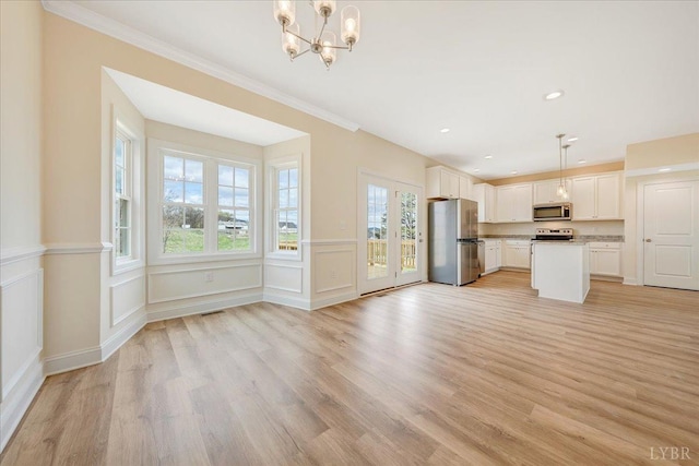 7 Lochwood Hill Dr, Goode, VA 24556 - kitchen featuring appliances with stainless steel finishes, a chandelier, white cabinetry, light wood-style flooring, and a center island