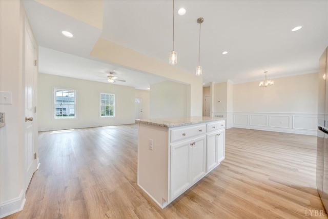 7 Lochwood Hill Dr, Goode, VA 24556 - kitchen with open floor plan, a chandelier, a ceiling fan, white cabinetry, and light wood-style flooring