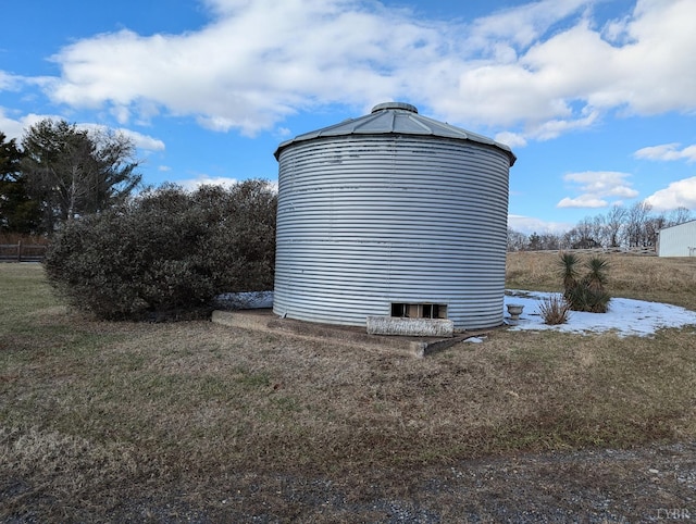 view of side of home with a yard