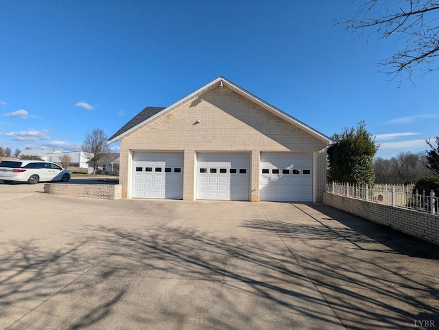 view of side of home featuring a garage and an outdoor structure