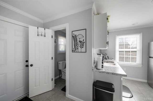 1516 Pierce St, Lynchburg, VA 24501 - laundry room featuring a sink, healthy amount of natural light, ornamental molding, light tile patterned floors, and baseboards