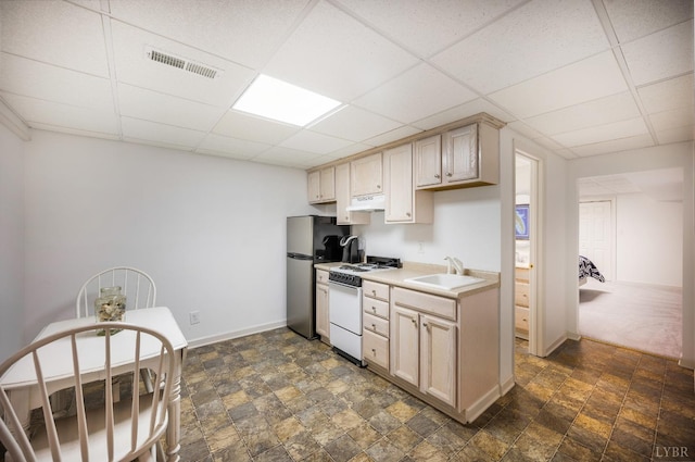 152 Fairwinds Ct, Forest, VA 24551 - kitchen featuring white range with gas stovetop, freestanding refrigerator, a sink, a paneled ceiling, and stone finish flooring