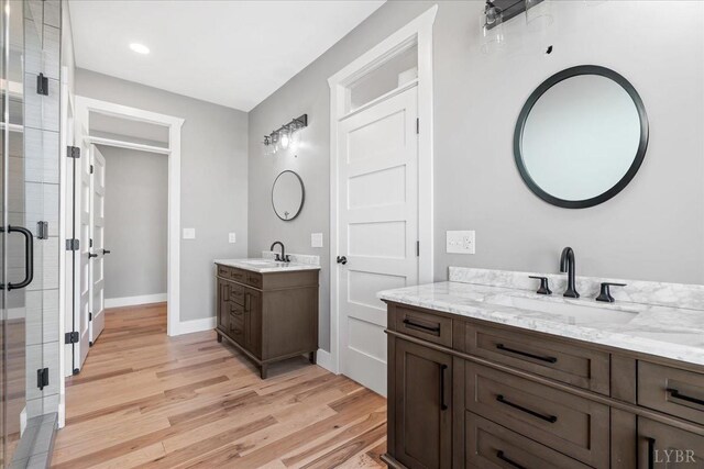 4615 Everett Rd, Forest, VA 24551 - full bath featuring two vanities, wood finished floors, a stall shower, and a sink