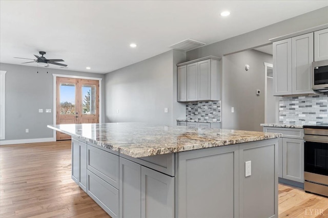4615 Everett Rd, Forest, VA 24551 - kitchen with a center island, stainless steel appliances, a ceiling fan, and gray cabinets