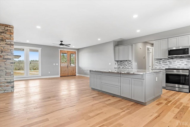 4615 Everett Rd, Forest, VA 24551 - kitchen featuring gray cabinetry, a center island, stainless steel appliances, and decorative backsplash