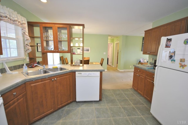 2453 Easome Rd, Hurt, VA 24563 - kitchen featuring white appliances, a sink, brown cabinetry, a peninsula, and light countertops