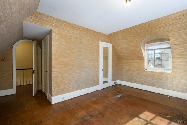 spare room featuring visible vents, baseboards, and dark wood-style floors