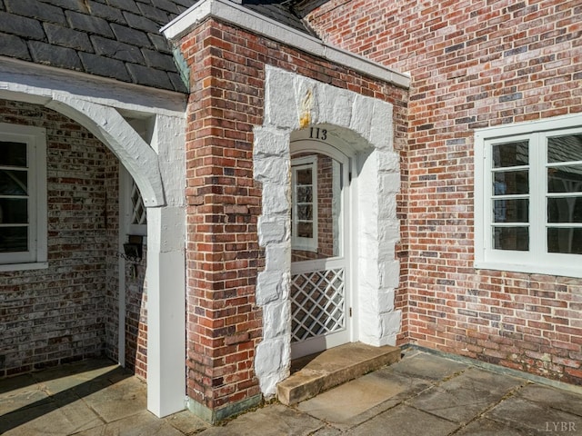 property entrance with brick siding